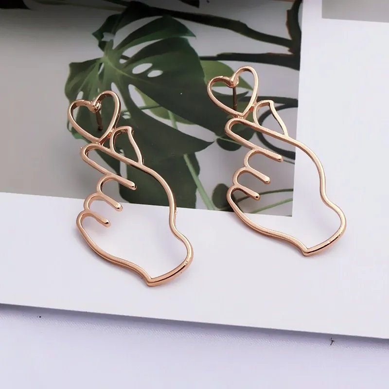 

Simple Design Gold Color Hollow Hand Earrings For Women New Brand Fashion Ear Piercing Heart Gesture Earring Gift