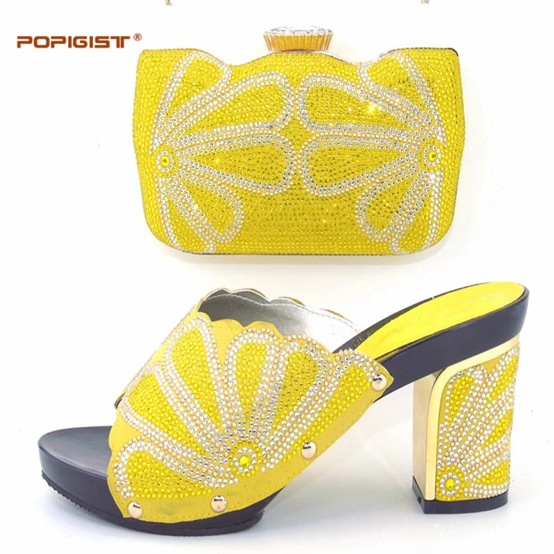 white heels and clutch bag