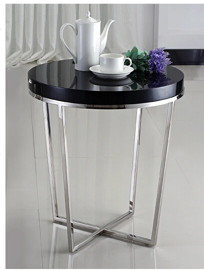 A few modern side. Small round tea table. The piano lacquer that bake the sofa side table white