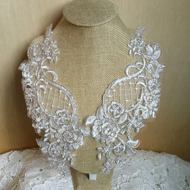 Add elegance and glamour with this high-quality lace fabric featuring flower appliques and sequins.