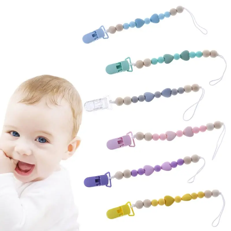 baby chewing on pacifier teething