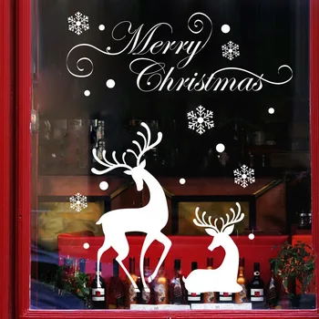 

White snowflake reindeer decorative wall stickers on display in Christmas home store windows