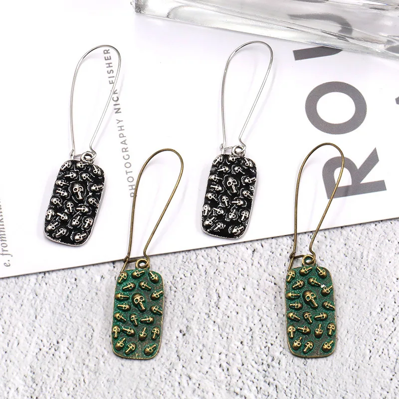 

New badge type bone head resin earrings cross black green ear hook personality national wind earrings female jewelry gift