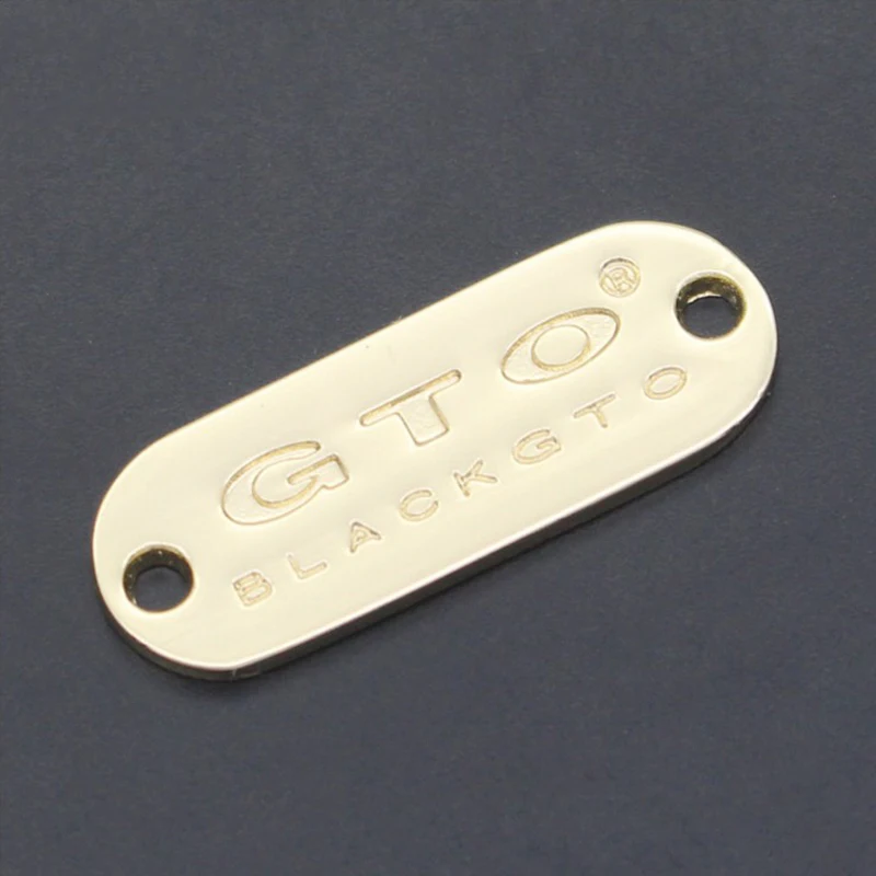 

custom high quality garment gold metal embossed labels handmade sewing labels for clothes 1*3cm GTO metal clothing labels