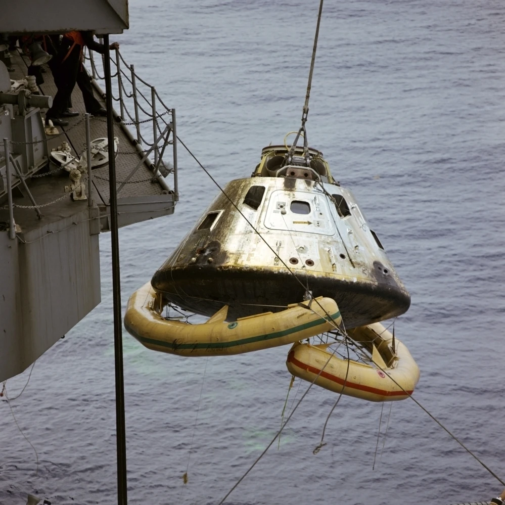 The Apollo 9 Command Module is hoisted aboard the recovery ship Poster Print (14 x 14)