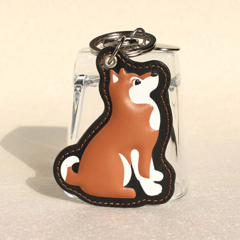 

Famous Brand Designer Genuine Leather Cute Puppy Dog Keychain For Car Keys Animal Key Chain Women Bag Chams Backpack Pendant
