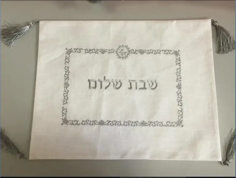 

White linen cover with white embroidery logo and four fringes for wedding