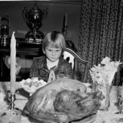 Girl praying before Thanksgiving meal Poster Print (24 x 36)