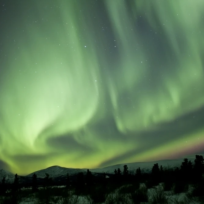 Aurora borealis over mountain  Yukon  Canada Poster Print (34 x 22)