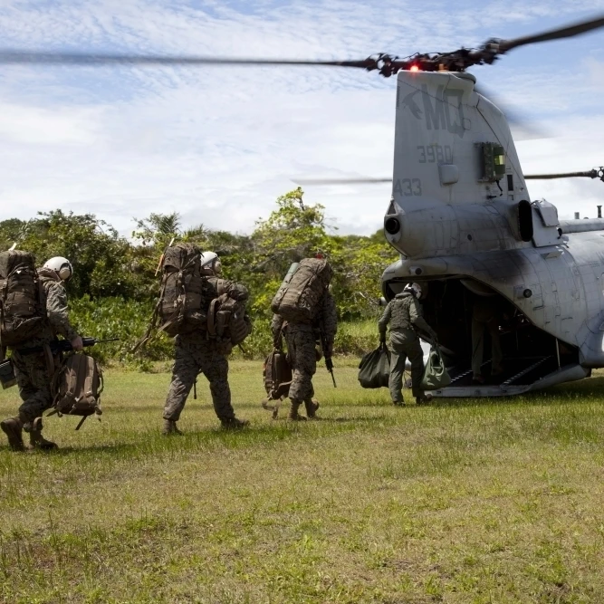 A U.S. Marine Corps CH-46E Sea Knight embarks Marines for transportation Poster Print (34 x 22)