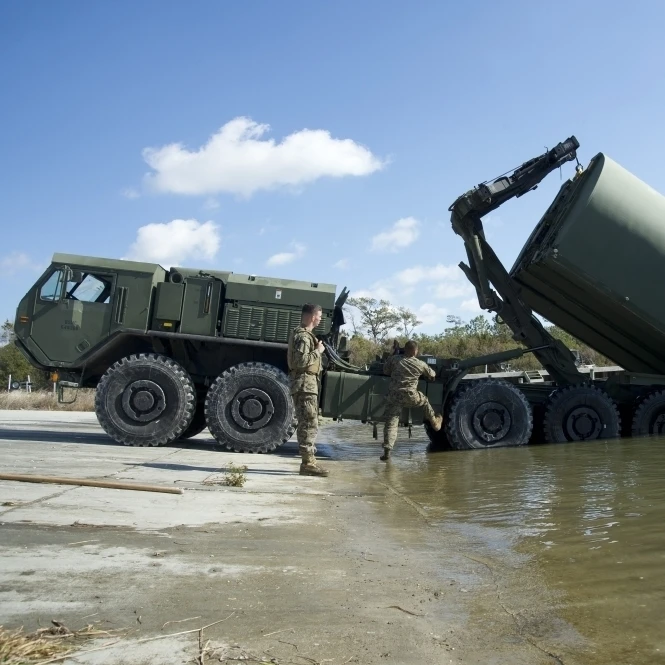Marines lower an improved ribbon bridge into the water Poster Print (17 x 11)