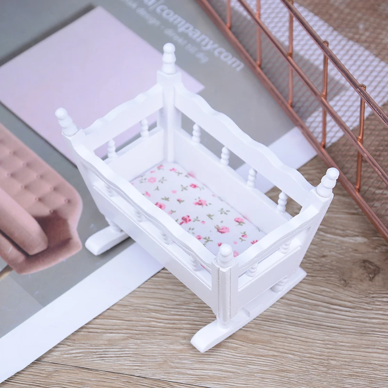 white wooden dolls cot