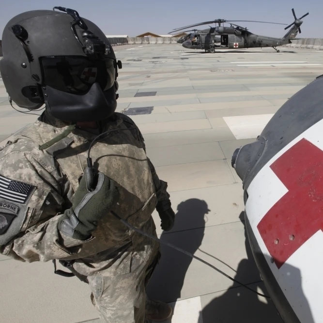 U.S. Army crew chief inspects the exterior of a UH-60 Black Hawk Poster Print (34 x 22)