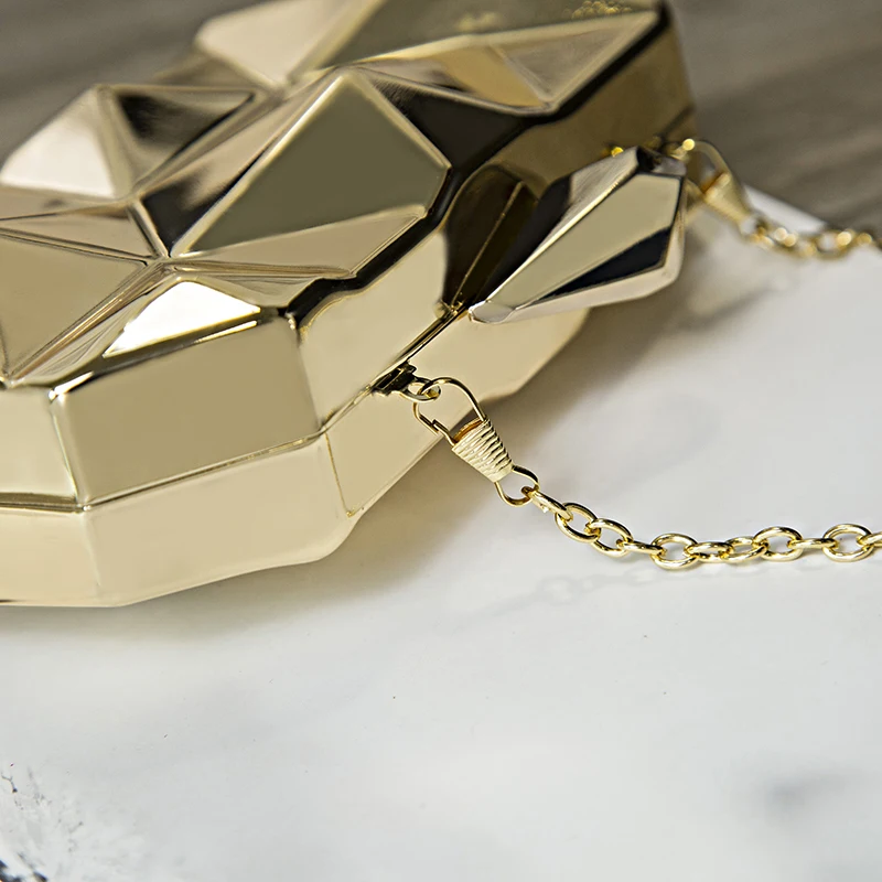 A acrylic box geometric clutch on a marble table.