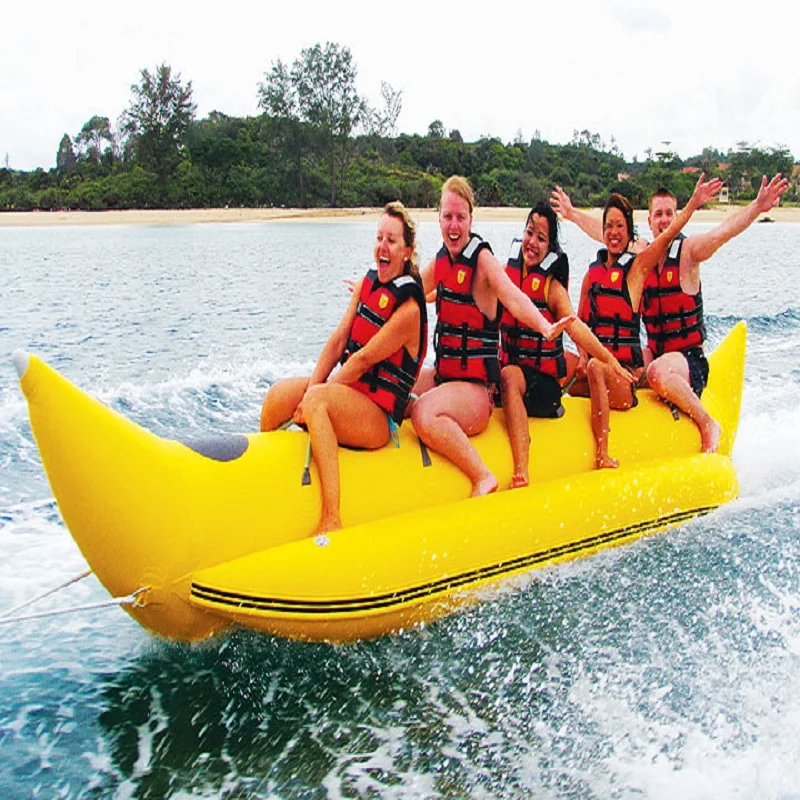 inflatable banana boat 5 people playing on the beach surf riding water