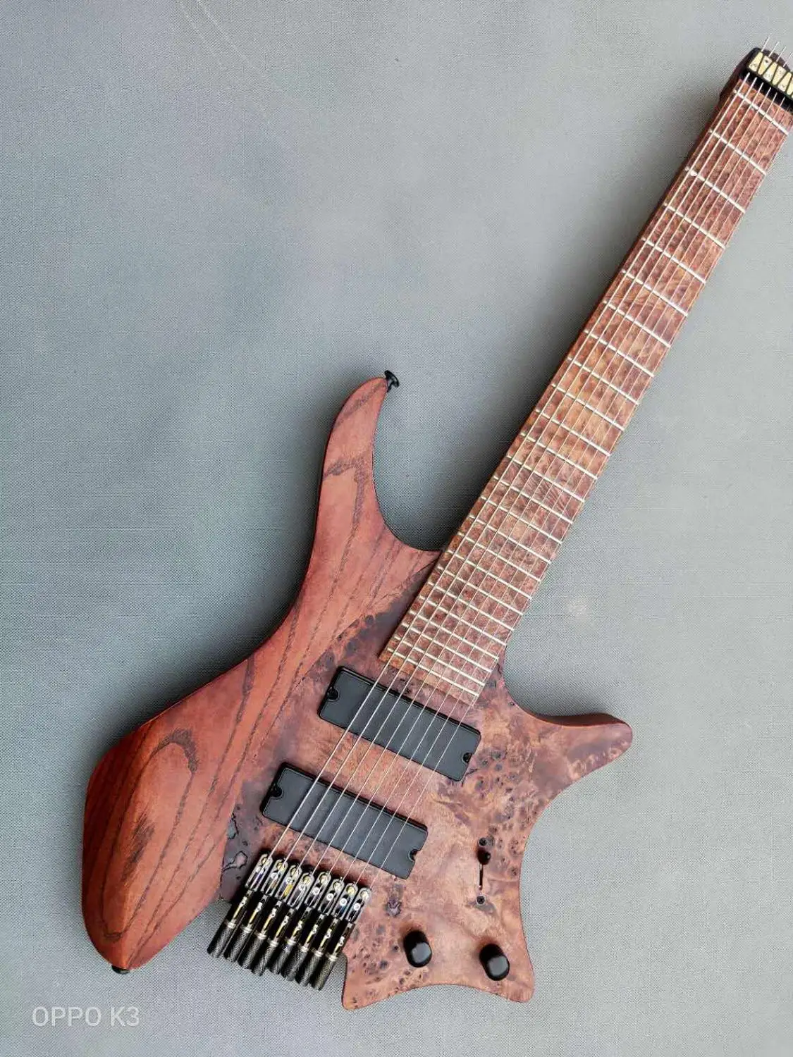 

Brand new custom 8 string headless electric guitar, tree scar veneer, coffee, new headless pull string board, twist neck, gold c