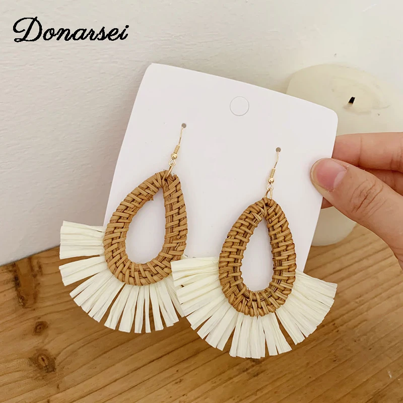 

Donarsei Fashion Water Drop Handmade Lafite Rattan Tassel Earrings For Women Bohemian Raffia Wooden Fringe Drop Earrings
