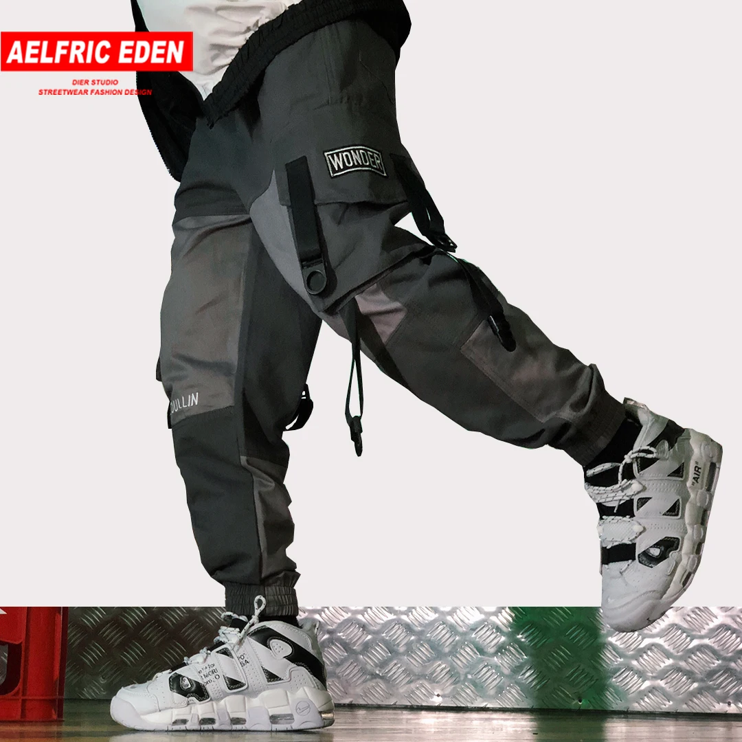 

Aelfric Eden New Ribbon Multi Pockets Stitch Patch Sweat Pants Hip Hop Buckle Streetwear Drawstring Casual Mens Pants Joggers