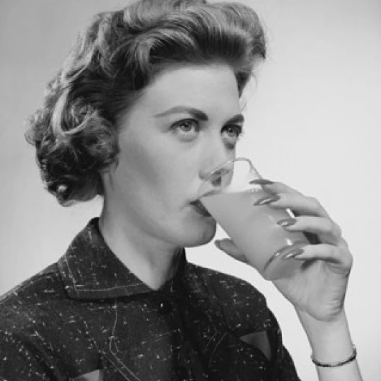 Close-up of a young woman drinking juice Poster Print (24 x 36)
