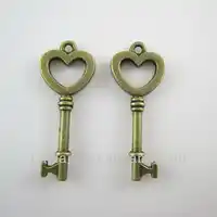 100pcs of Antique bronze tone jewelry findings small key shaped charm pendant