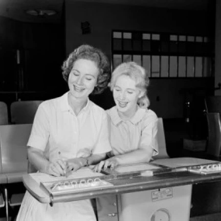 Two women filling in papers Poster Print (18 x 24)