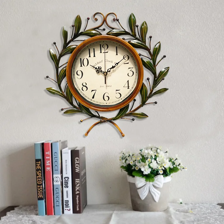 

Idyllic Creative Wrought Iron Olive Branch Clock Round Wall Clock Modern Design Living Room Cafe Quiet Decorative Quartz Clock