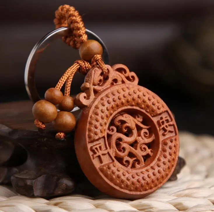 

Chinese Peach Wood Carved Safe And Good Luck Animals Dragon Phoenix Button Exquisite Car Key Chain Pendant