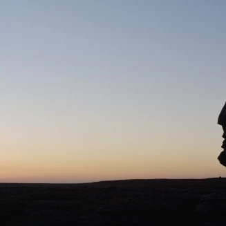 Silhouette Of Head-Shaped Boulder At Dusk Poster Print (37 x 12)
