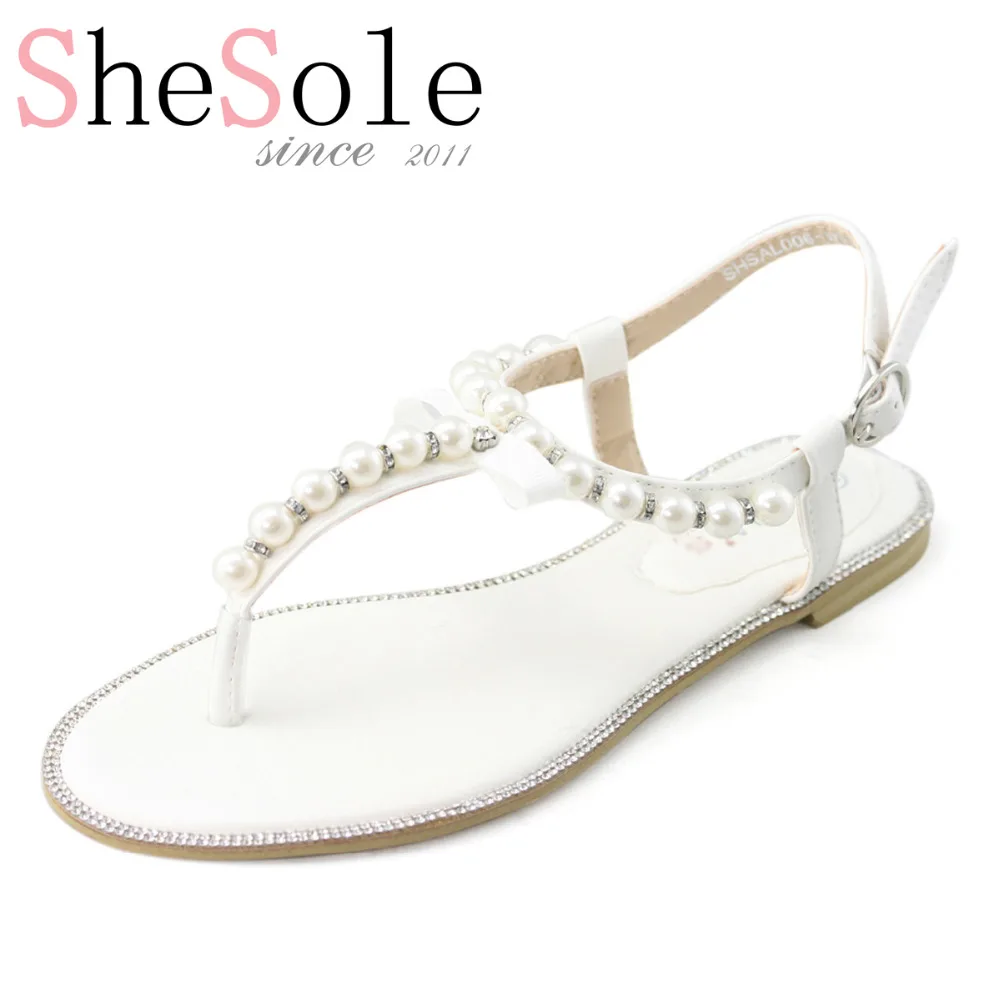 white flats with pearls
