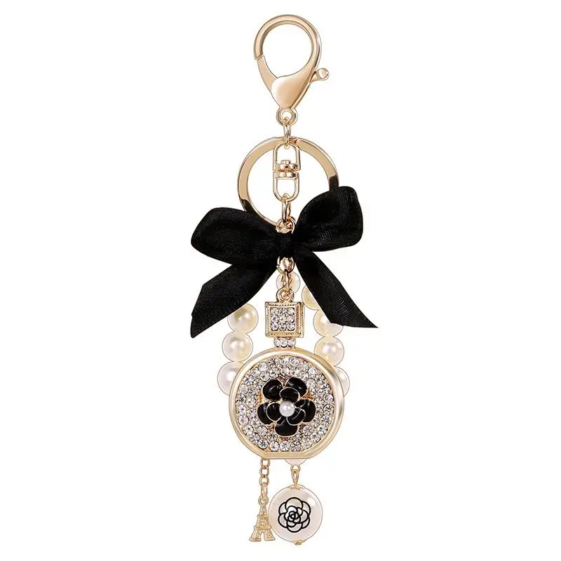 

New creative bow crystal perfume bottle keychain Pearl car key ring Female bag pendant accessories Charm jewelry keychain