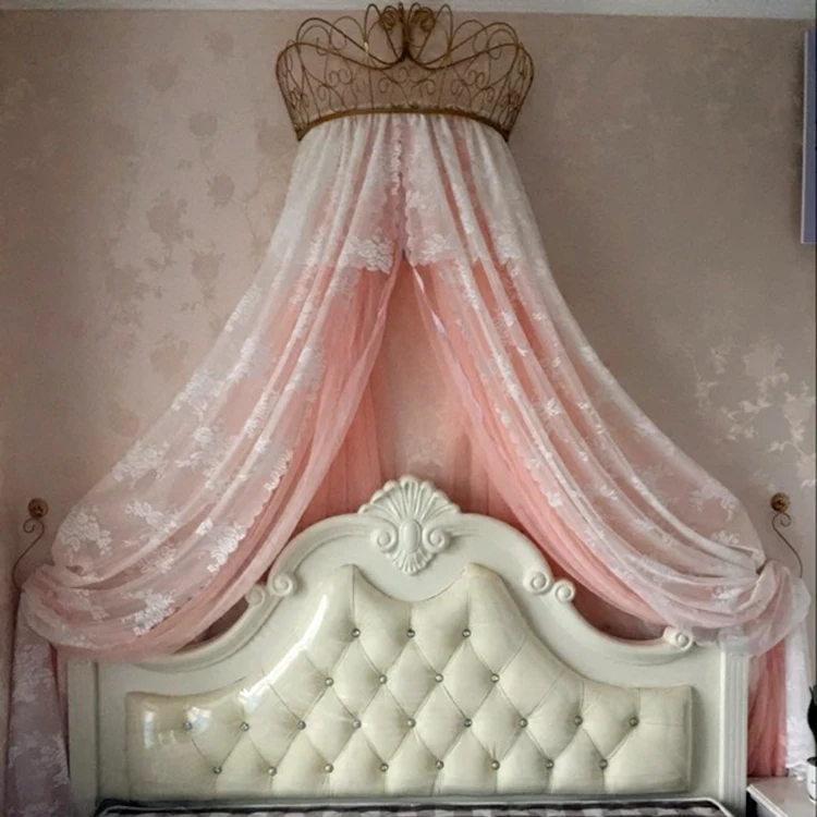 gold and white mosquito net adorns the crown shelf