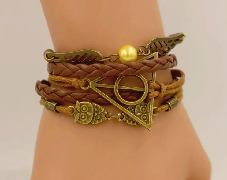 

HOT Harri Potter Death Hallows Retro Leather Cord Bracelet Golden Wings Flying Thief Triangle Action Figure Multilayer Bracelet