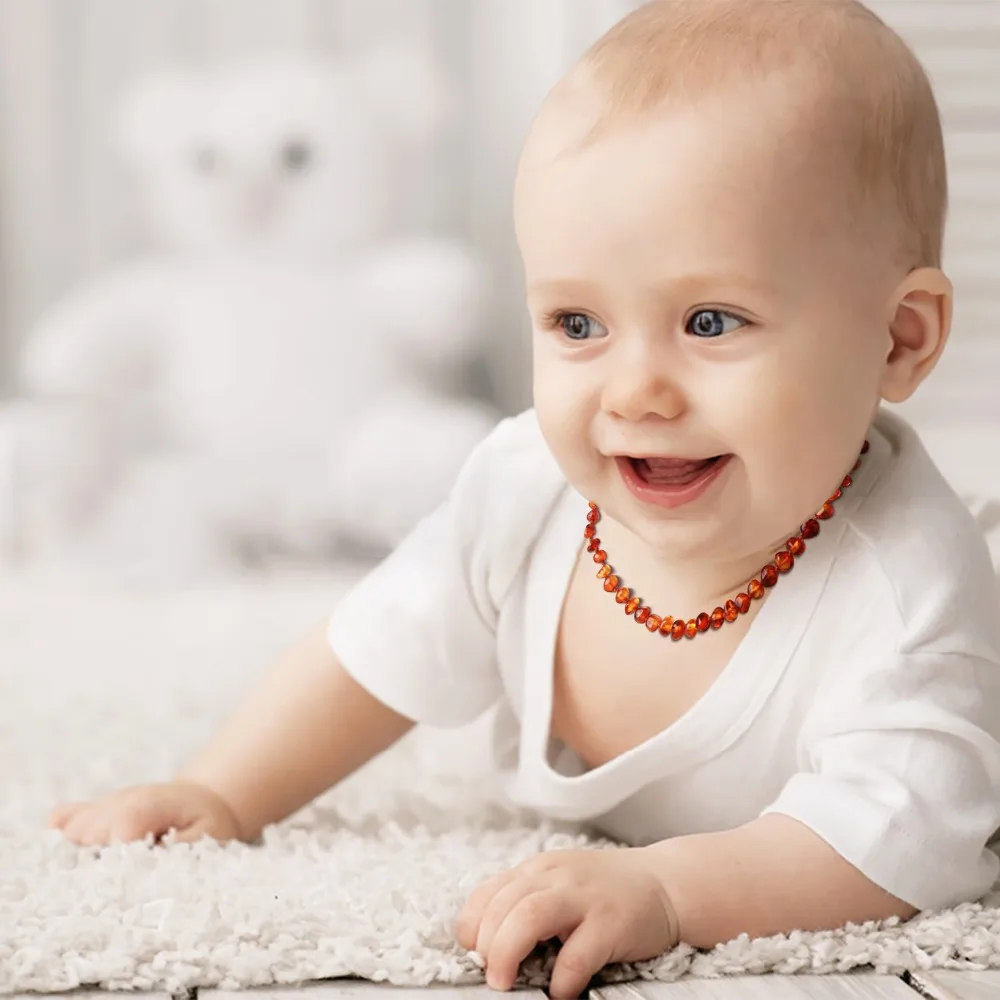 baby with amber necklace