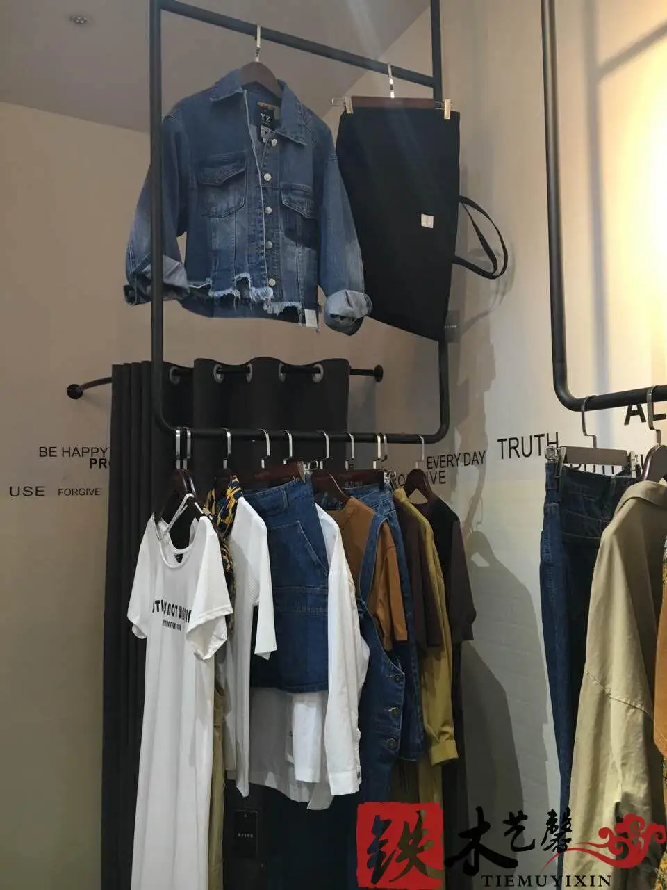 Black and white clothes hanging gantry. Clothing display shelf, display stand, ceiling hangs clothes hangers