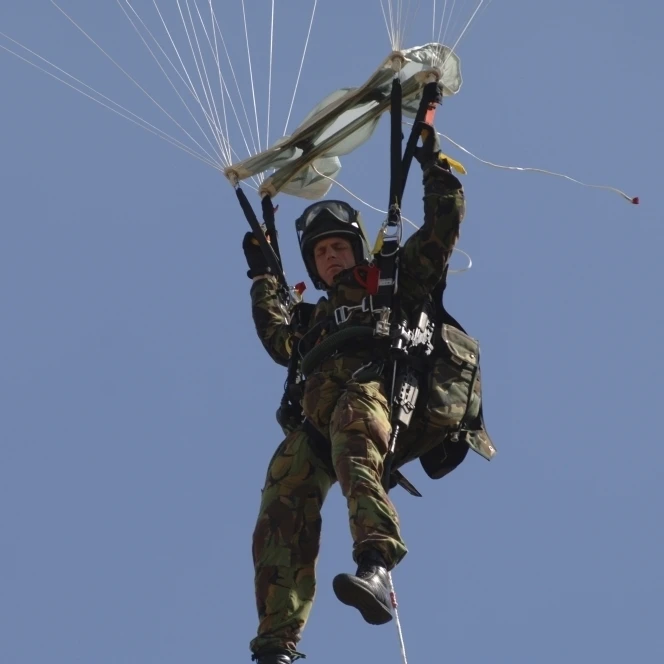 A member of the Pathfinder Platoon prepares to land from a parachute jump Poster Print (34 x 22)
