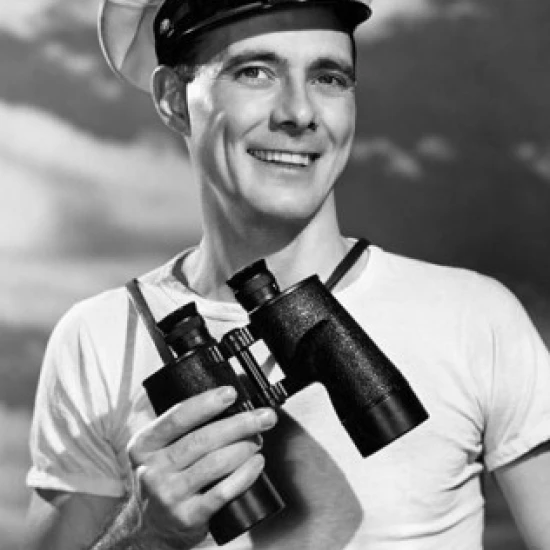 Portrait of a sailor holding a pair of binoculars and smiling Poster Print (18 x 24)
