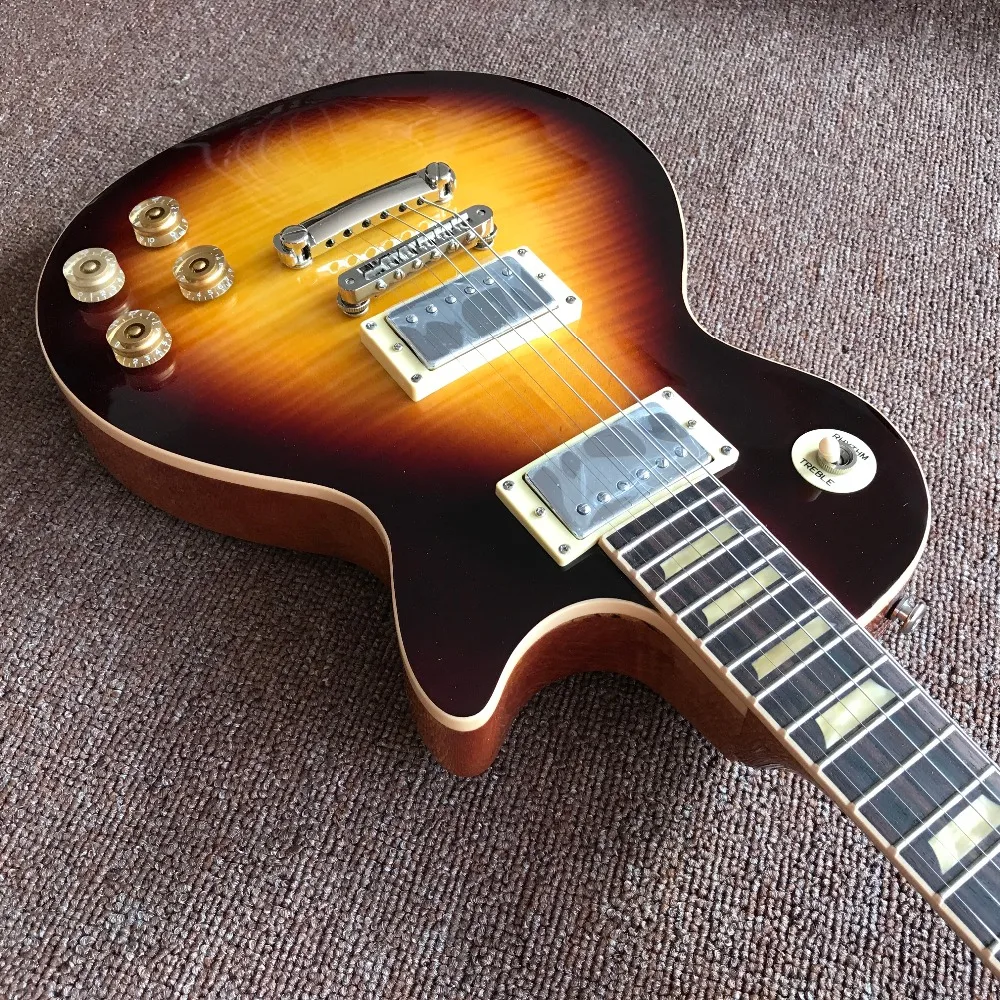 

one piece body and neck in sunburst color with yellow inlays , Upgrade Tune-o-Matic bridge with cream frets end binding guitarra