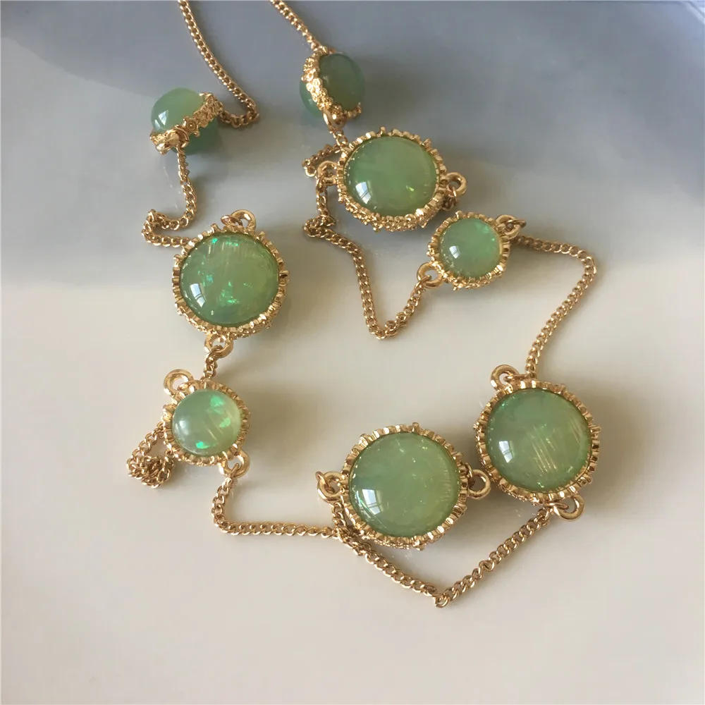 

Gold color green stone side engraved pendant long necklace for women