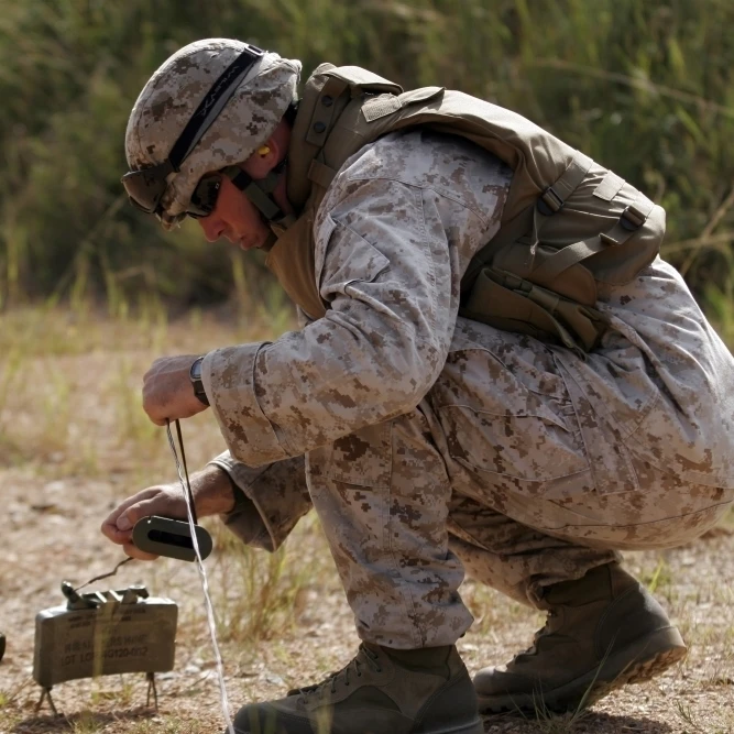 A U.S. Marine places a claymore mine Poster Print (33 x 22)