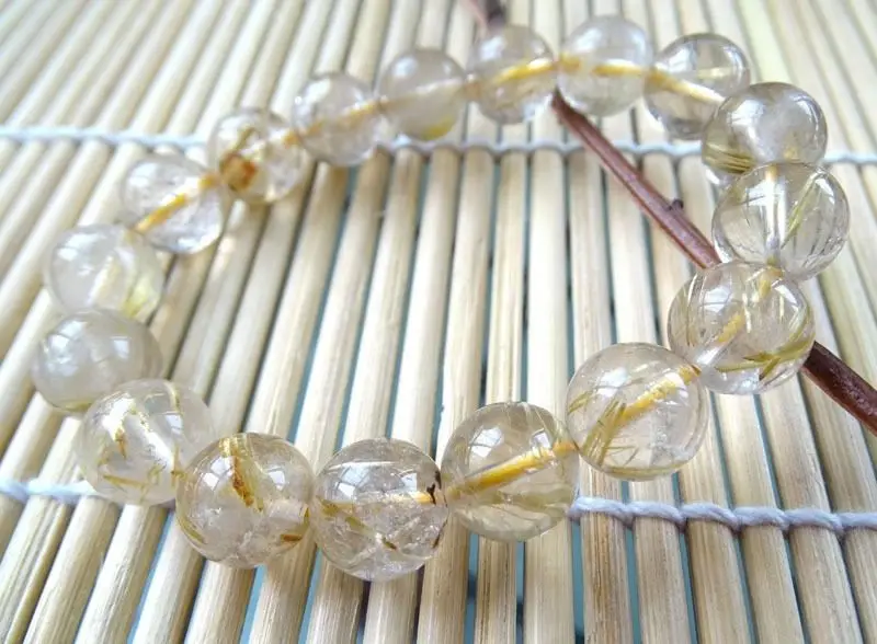 

001981 natural golden rutilated quartz rock round stretch bracelet