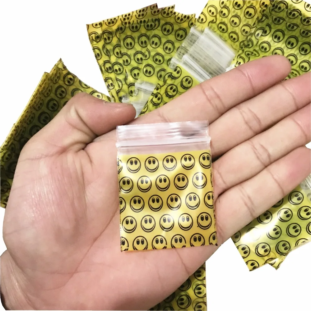 

1 pack (100 pieces) hot new tobacco bag tobacco sealed bag storage bag Smile pattern with holder tobacco bag Burning piece gift