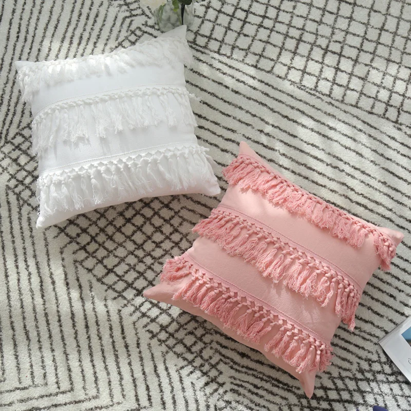 pink pillow with tassels