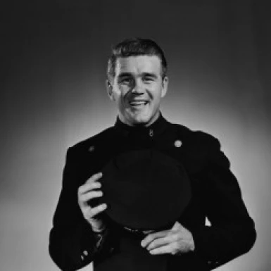 Portrait of mature smiling man in uniform  studio shot Poster Print (18 x 24)