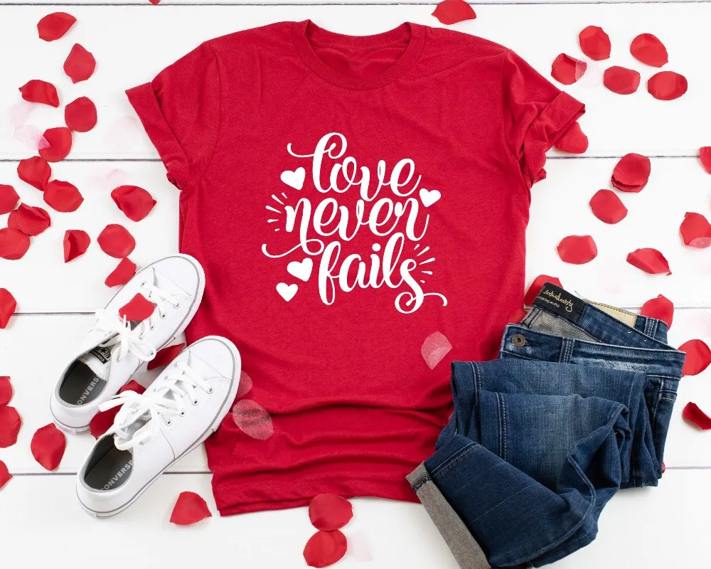 

Valentine Shirt Love Never Fails Christian Shirt Positive Message heart graphic women fashion lover new year red grunge tee tops