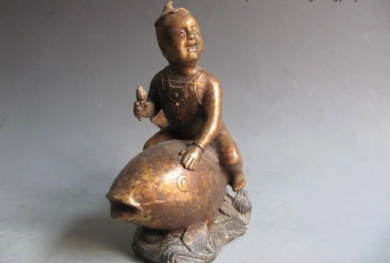 

Chinese Old Bronze Copper Carved Lucky Money childie Boy Ride on Fish Statue