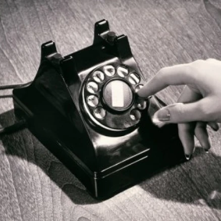Close-up of a person's hand dialing a number on a rotary telephone Poster Print (18 x 24)