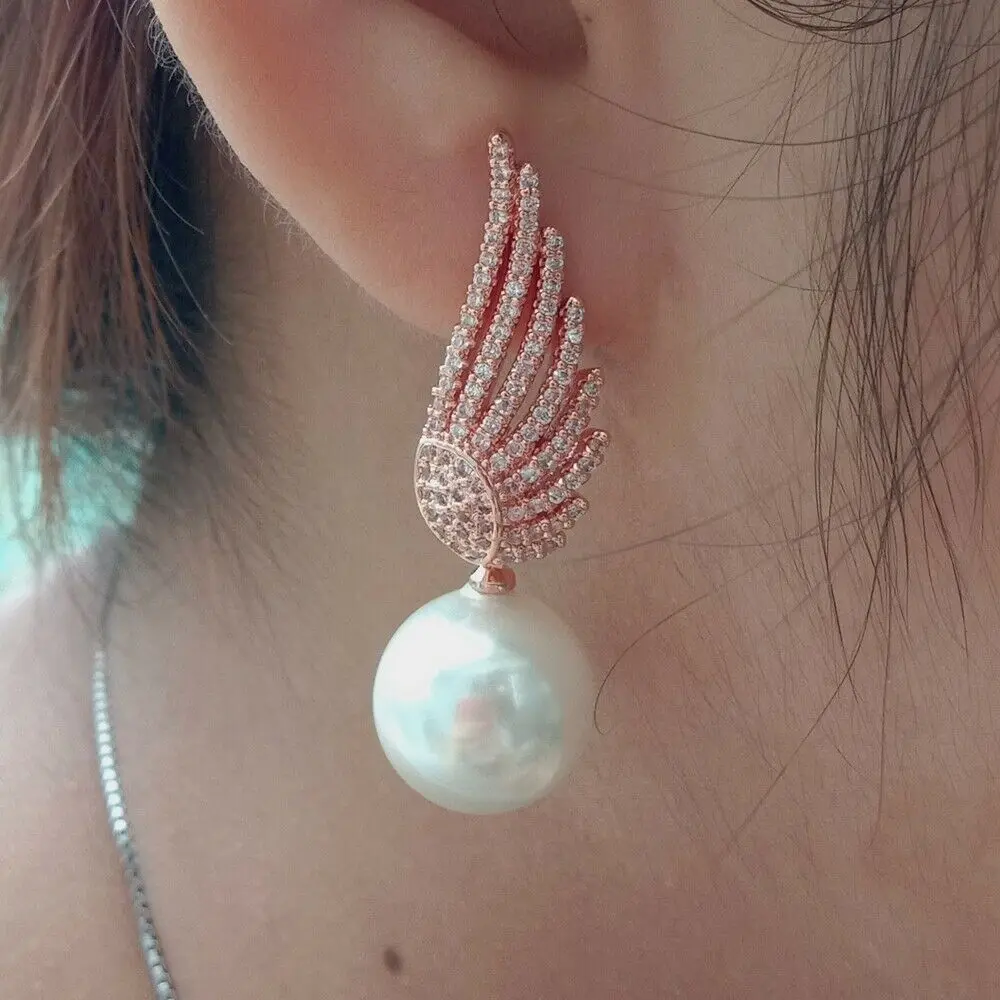 

Women's 14mm White Sea Shell Pearl Rose Golden Plated Wing Earrings