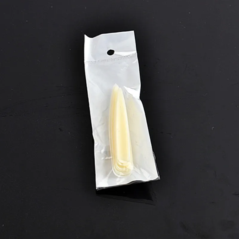 

False nail salon Manicure pointed nail samples show a lengthened false nails on the nail art stage