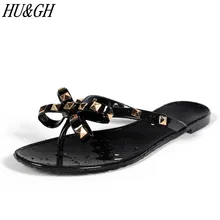 Лидер продаж; женские шлепанцы на плоской подошве с заклепками и бантом; шлепанцы для девочек; Летняя обувь; крутые пляжные прозрачные туфли; модные крутые женские шлёпанцы