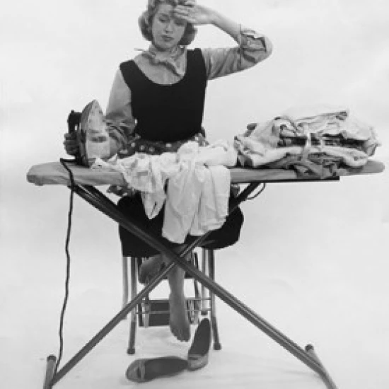 Young woman ironing on clothes Poster Print (18 x 24)